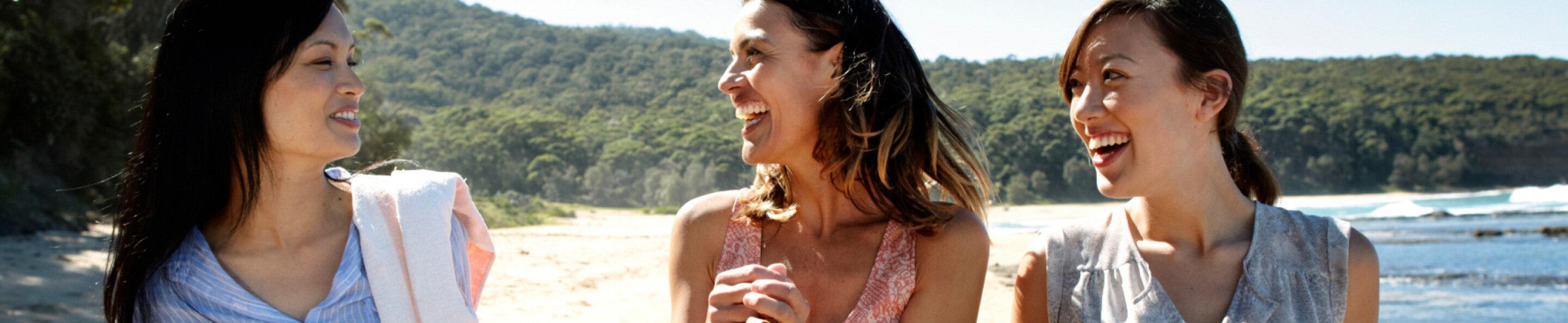 friends laughing together on a secluded beach
